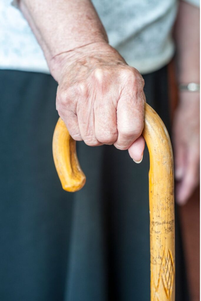 Old man taking support